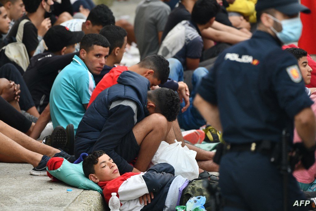 Migrant minors wait to be tested for COVID-19 upon their arrival to the Spanish enclave of Ceuta, on May 19, 2021. - Migrants were still trying to cross from Morocco into the Spanish enclave of Ceuta after a record 8,000 people poured over the border this week, escalating tensions between Rabat and Madrid. (Photo by Antonio Sempere / AFP) / Restricted to editorial use - To illustrate the event as specified in the caption