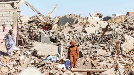 Villagers inspect the rubble of collapsed houses in Tafeghaghte, 60 kilometres (37 miles) southwest of Marrakesh, on September 10, 2023, two days after a devastating 6.8-magnitude earthquake struck the country. Moroccans on September 10 mourned the victims of a devastating earthquake that killed more than 2,000 people as rescue teams raced to find survivors trapped under the rubble of flattened villages. (Photo by FADEL SENNA / AFP)